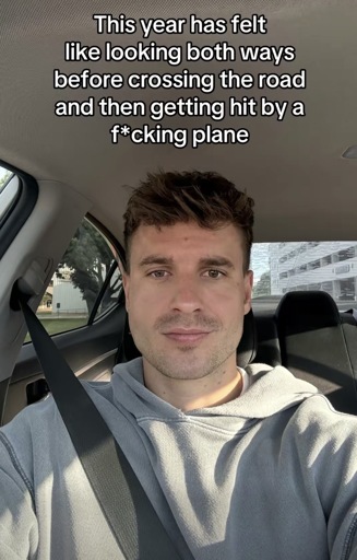 Selfie photo of a person with the caption, “This year has felt like looking both ways before crossing the road and then getting hit by a f*cking plane”