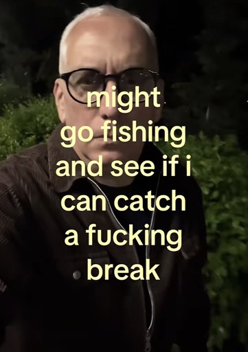 Selfie of a person outside at night with the caption (yellow text) “might go fishing and see if i can catch a fucking break”